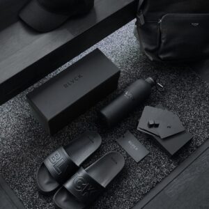 black sony remote control beside black leather bag